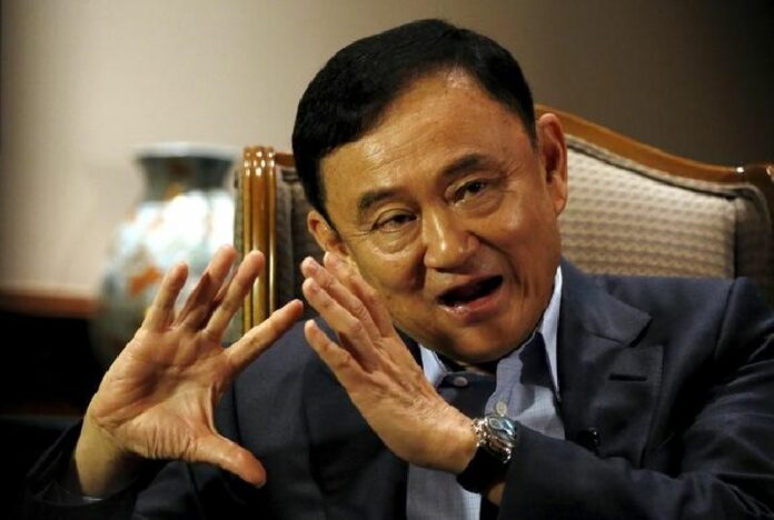 Former Prime Minsiter Thaksin Shinawatra speaks during a Feb. 23, 2016, interview in Singapore. Photo: Edgar Su / Reuters Pheu Thai Party Could be Dissolved if Under Thaksin: EC