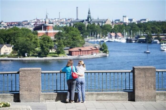 In this July 2, 2015 file photo, tourists looking at a view of Stockholm. Photo: Jessica Gow / Associated Press