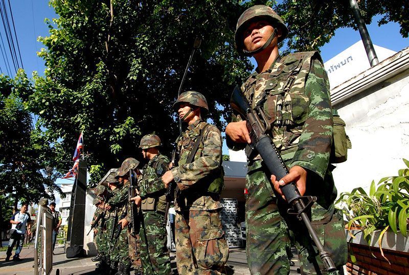 Soldiers posted outside an army auditorium where civilians were being brought in for ‘attitude adjustment’ one day after the coup on May 23, 2014, in Bangkok.