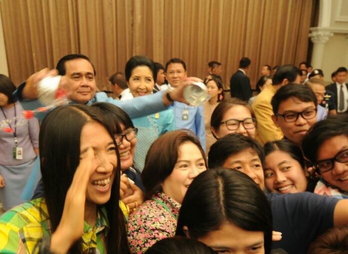 Gen. Prayuth Chan-ocha splashes water on the media Tuesday morning at Government House