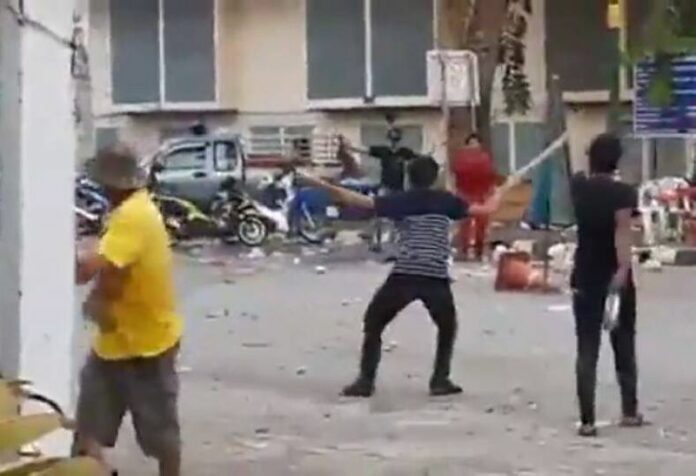 Young alleged gang members square off and throw various objects at each other Friday north of Bangkok in Pathum Thani province in a video still image.