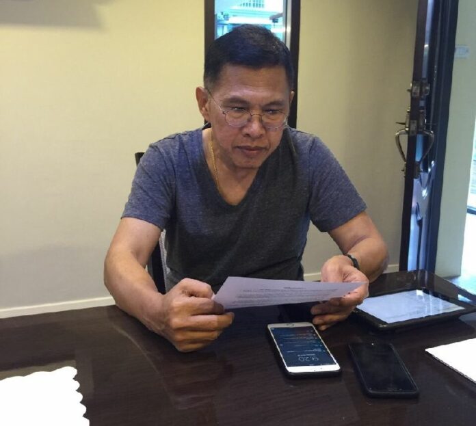 In this image distributed to reporters by the Pheu Thai Party, Watana Muangsook poses for a photo at an undisclosed location Monday prior to turning himself in to the military at the 11th Army Circle base in Bangkok.
