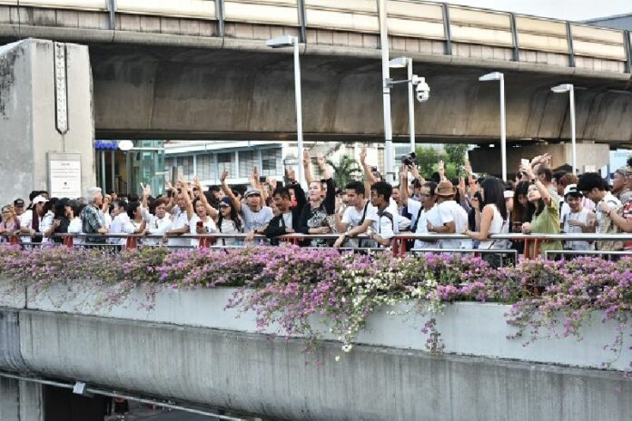 Protesters raised three fingers in the ‘Hunger Games’-inspired salute which has been adopted as a symbol of protest against the junta Tuesday evening at Victory Monument in Bangkok.