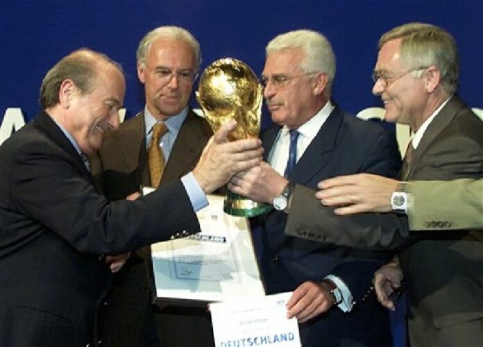 In this July 6, 2000, file photo, FIFA President Sepp Blatter, left, hands over a copy of the soccer World Cup trophy to the German bid team, Franz Beckenbauer, second from left, Fedor Radmann, second from right, and Horst R. Schmidt, right, after FIFA announced that Germany will host the soccer World Cup 2006, in Zurich, Switzerland. Photo: Michel Euler / Associated Press