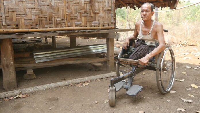 Kyar Khin, a farmer in Aung Chan Thar village in Kyaukkyi township in eastern Myanmar’s Kayin State, lost both his legs following a land mine injury. Photo: David Doyle / Myanmar Now