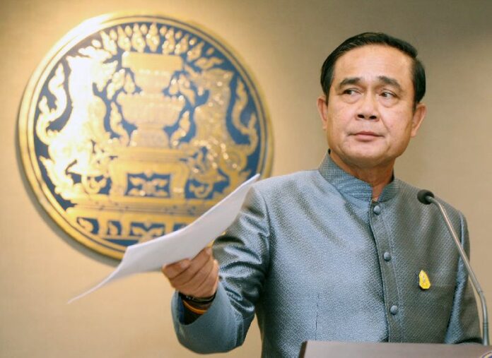 Junta chairman Prayuth Chan-ocha addresses reporters Tuesday at Government House in Bangkok.