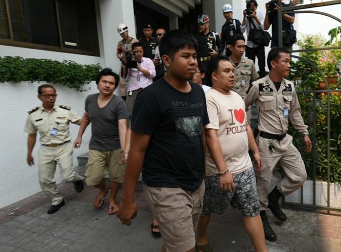 Shackled together, suspects accused of sedition and computer crimes are led Friday afternoon from a military court in Bangkok where they were denied bail and remanded into custody.
