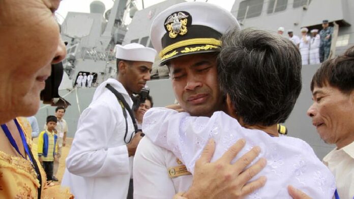 Cmdr. Michael Vannak Khem Misiewicz embraces his aunt at the port of Sihanoukville, Cambodia, in an emotional return to his birthplace in 2010. Photo: Heng Sinith / Associated Press<br />