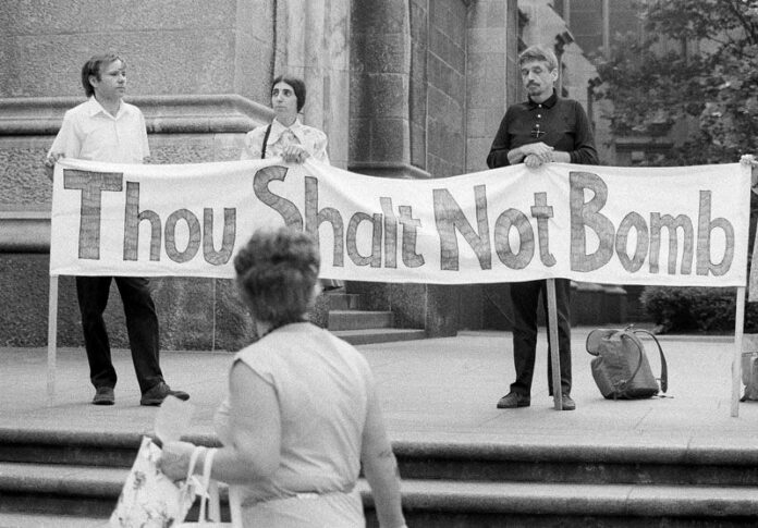 Rev. Fr. Daniel Berrigan and friends participate in a 1973 fast and vigil to protest the bombing in Cambodia, on the steps of St. Patrick’s Cathedral in New York City. Photo: Ron Frehm / Associated Press