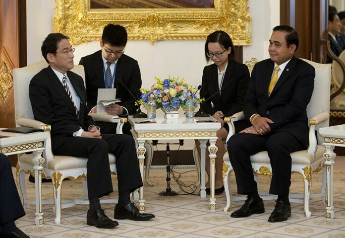 Prime Minister Prayuth Chan-ocha sits with Japan's Foreign Minister Fumio Kishida at a Monday meeting at Government House in Bangkok. Photo: Mark Baker / Associated Press