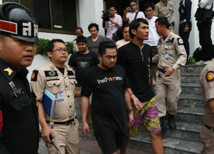 The eight suspects accused of sedition and computer crimes are led Friday afternoon from a military court in Bangkok where they were denied bail and remanded into custody.