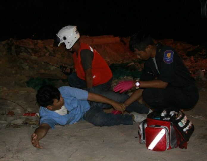 Rescue workers render first aid to baht bus driver Somchai Intasoi on Friday morning