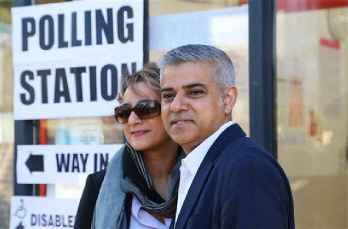 London mayoral candidate Labour Party's Sadiq Khan arrives with his wife Saadiya to cast their votes at a polling station in Streatham, south west London, Thursday May 5, 2016. Photo: Philip Gareth Fulller / PA / Associated Press