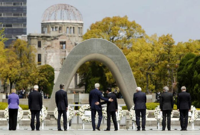 In this April 11, 2016, file photo, U.S. Secretary of State John Kerry, fourth from left, puts his arm around Japanese Foreign Minister Fumio Kishida after they and fellow G7 foreign ministers laid wreaths at the cenotaph at Hiroshima Peace Memorial Park in Hiroshima, western Japan. Photo: Jonathan Ernst / Associated Press