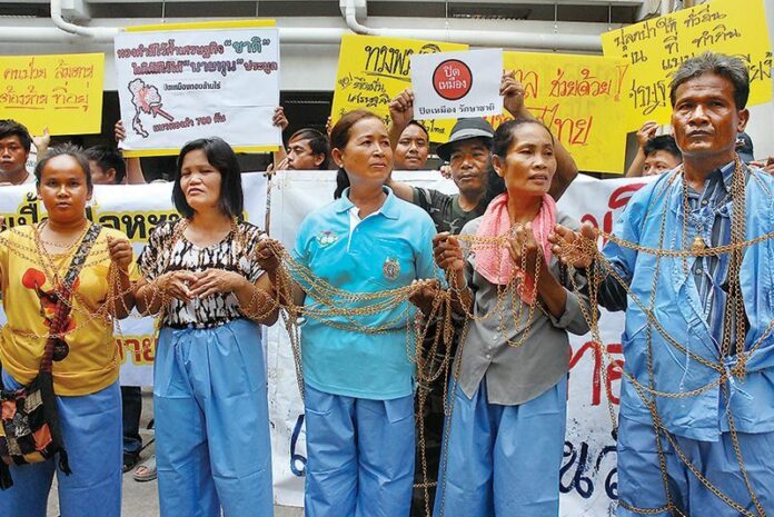Representatives from 12 provinces across the country protest Sept. 22 at Government House in Bangkok, where they filed a complaint urging the junta chief to shut down all of Thailand’s gold mines.