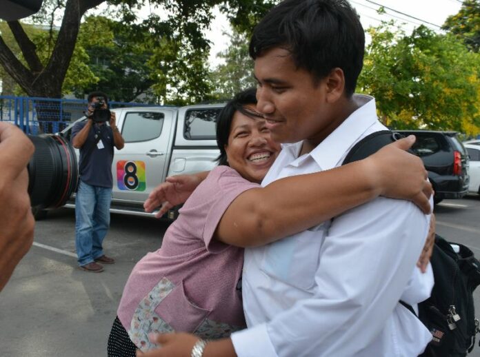 Patnaree Chankij embraces her son, student activist Sirawith Seritiwat, outside the Bangkok women’s prison where she was released Sunday.
