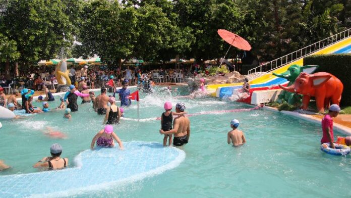 People cool down May 7 at a Korat waterpark.