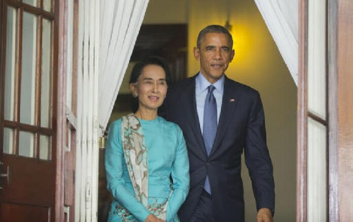 In this Nov. 14, 2014 file photo, Aung San Suu Kyi, walks with President Barack Obama for their joint news conference at her home in Yangon, Myanmar. Photo: Pablo Martinez Monsivais / Associated Press