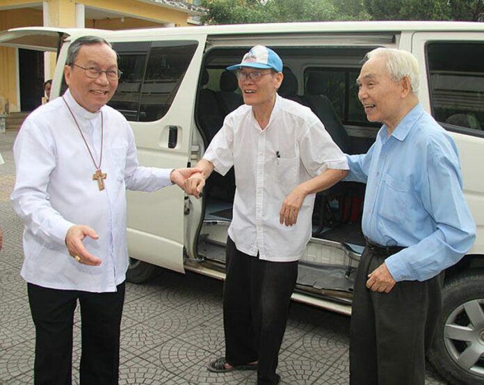 Catholic priest Nguyen Van Ly, center, is welcomed back by Archbishop Tadeo, left, and a senior colleague to his parish in Hue, Ha Nam province, Vietnam Friday. Photo: Catholic Archdiocese of Hue / Associated Press<br />