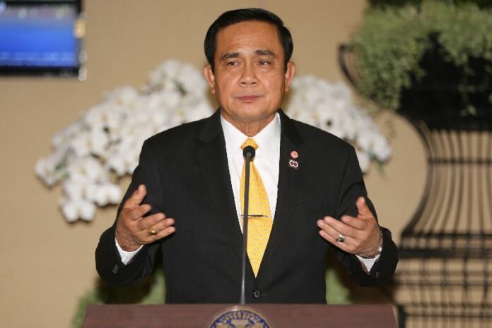 Junta chairman Prayuth Chan-ocha speaks to reporters May 21 in Bangkok