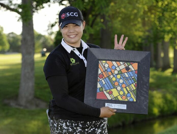 Ariya Jutanugarn, of Thailand, stands with the LPGA Volvik Championship trophy after winning the golf tournament at the Travis Pointe Country Club, Sunday, May 29, 2016 in Ann Arbor, Mich. Jutanugarn is holding up three fingers to signify that she has won three LPGA tournaments in a row. Photo: Jose Juarez / Associated Press