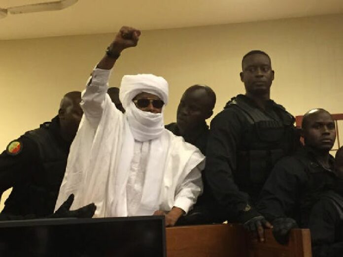 Chad's former dictator Hissene Habre raises his hand during court proceedings in Dakar, Senegal, Monday, May 30, 2016. Photo: Carley Petesch / Associated Press